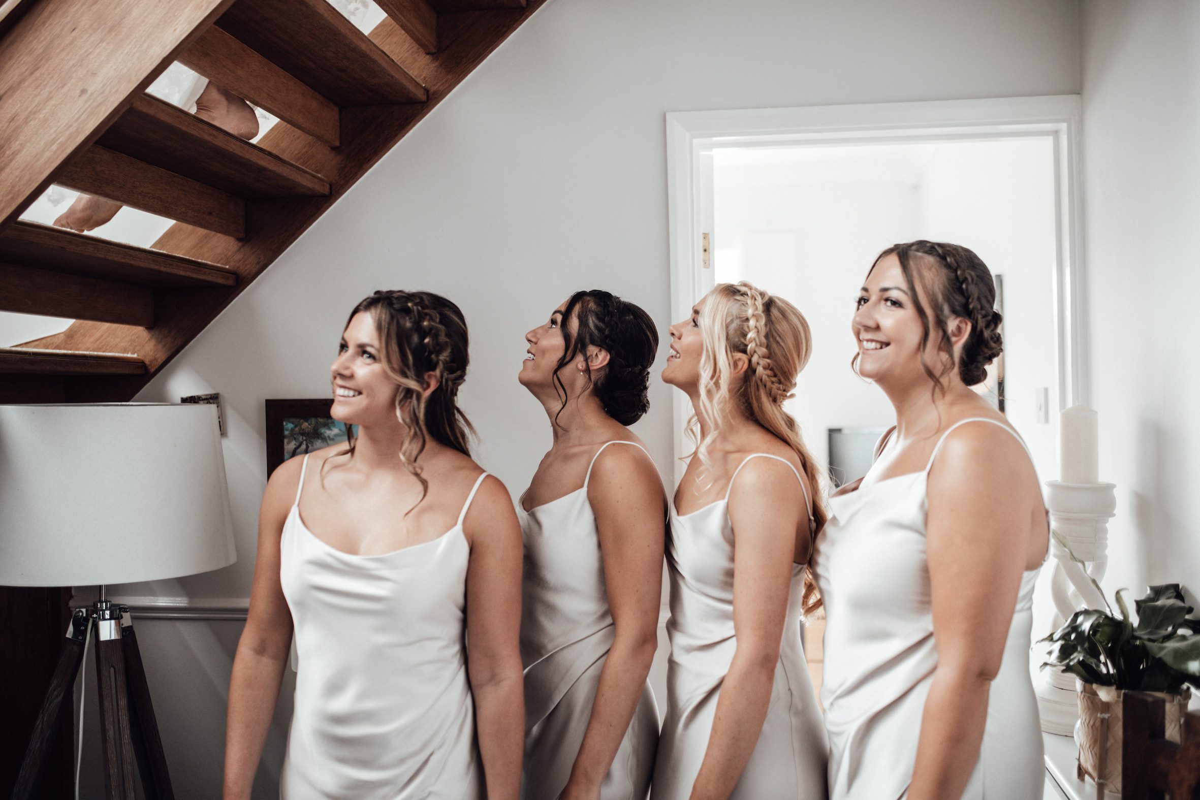 bridesmaids in white dresses waiting for bride