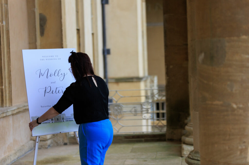 wedding co-ordinator putting out welcome sign